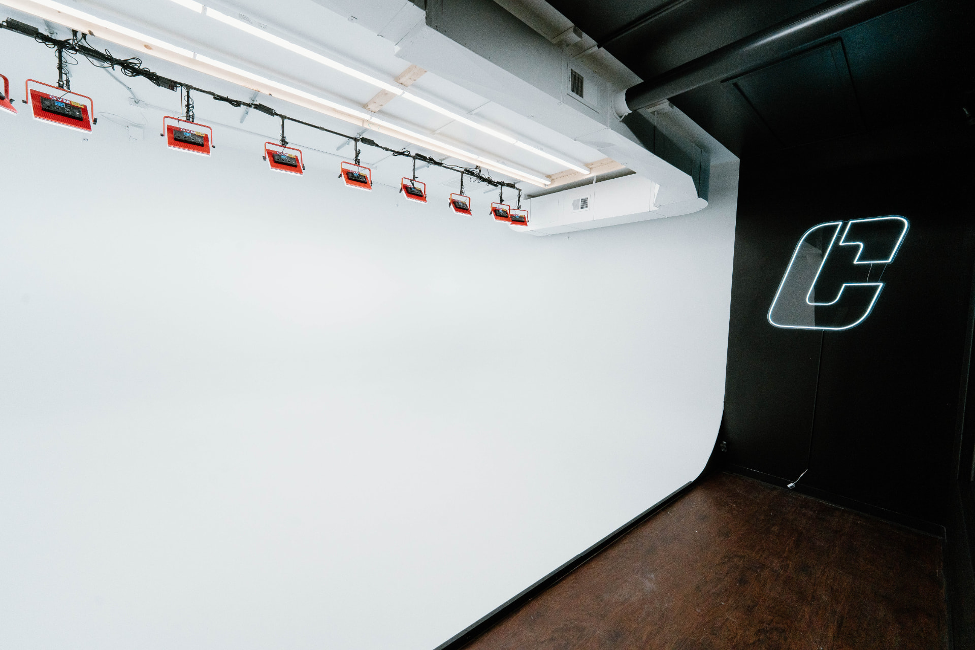 Our privately owned white cyclorama wall studio with lighting stands